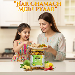 Kashmir Delights traditional mango khatta meetha pickle in mustard oil, shown in a glass jar with vibrant mango pieces and spices.